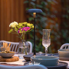 in-lite SWAY TABLE portable outdoor table light illuminating dining table in garden.