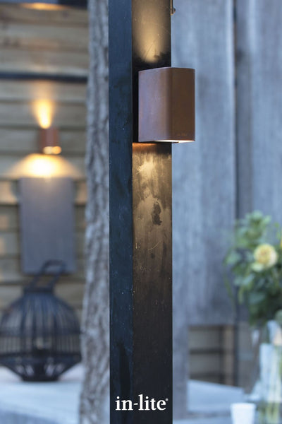 Atmospheric lighting by in-lite. ACE UP DOWN CORTEN 12v outdoor facade lighting fixtures positioned in decoratively landscaped contemporary garden.